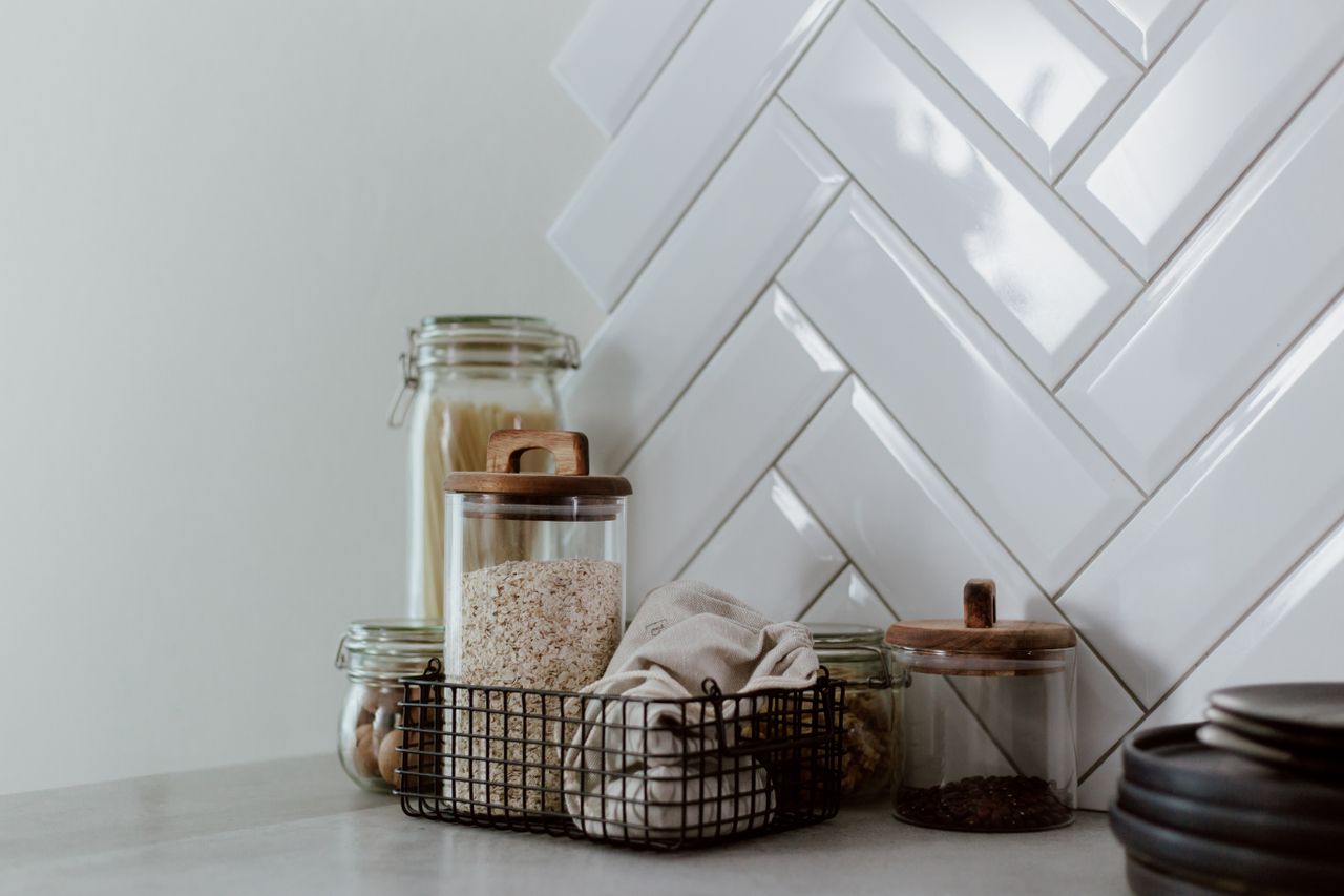 The Art of Drawing Readers In: Your attractive post title goes here Stylish kitchen setup featuring glass jars with pasta and grains on a clean counter.